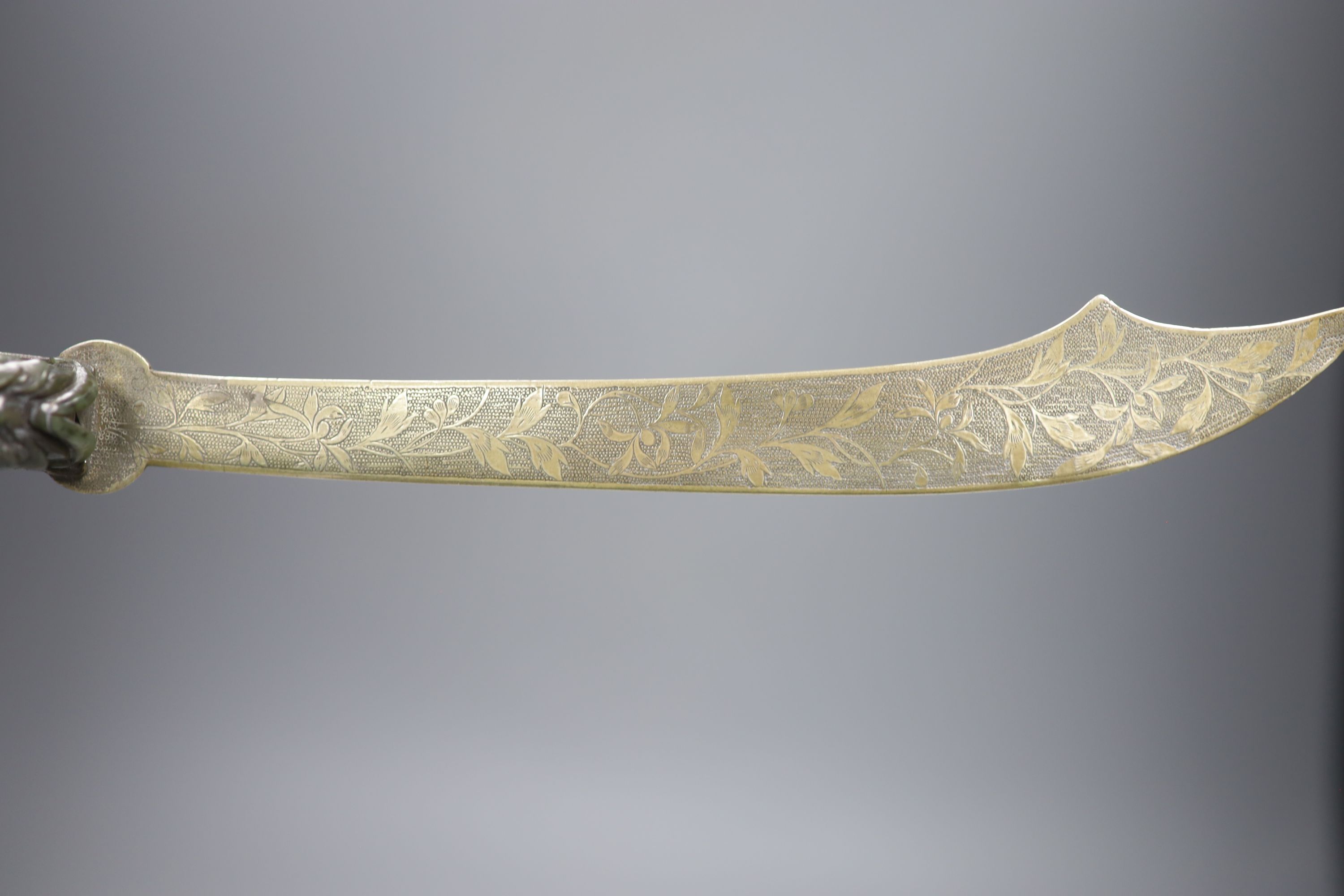 An 18th/19th century Chinese spinach green jadeite dragon belt hook, mounted as the handle for a paperknife, length 32cm